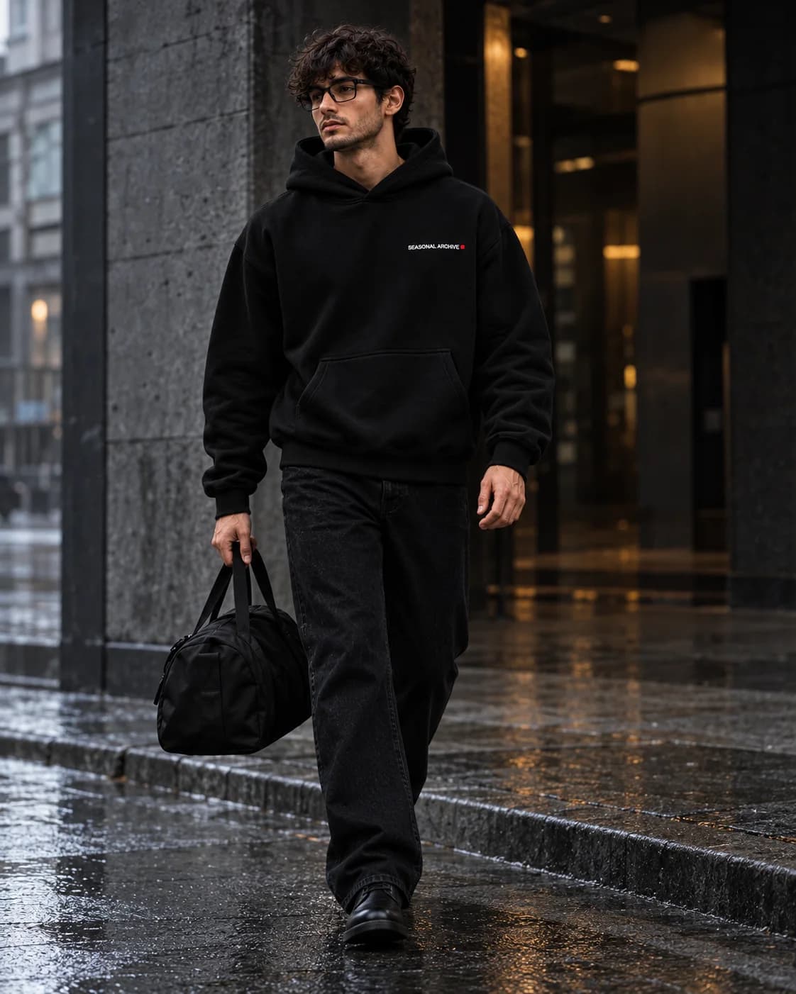 Walking through the city in the rain, gym bag in hand.